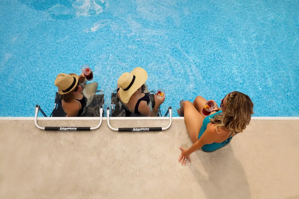 Women poolside enjoying the Edgemate chair