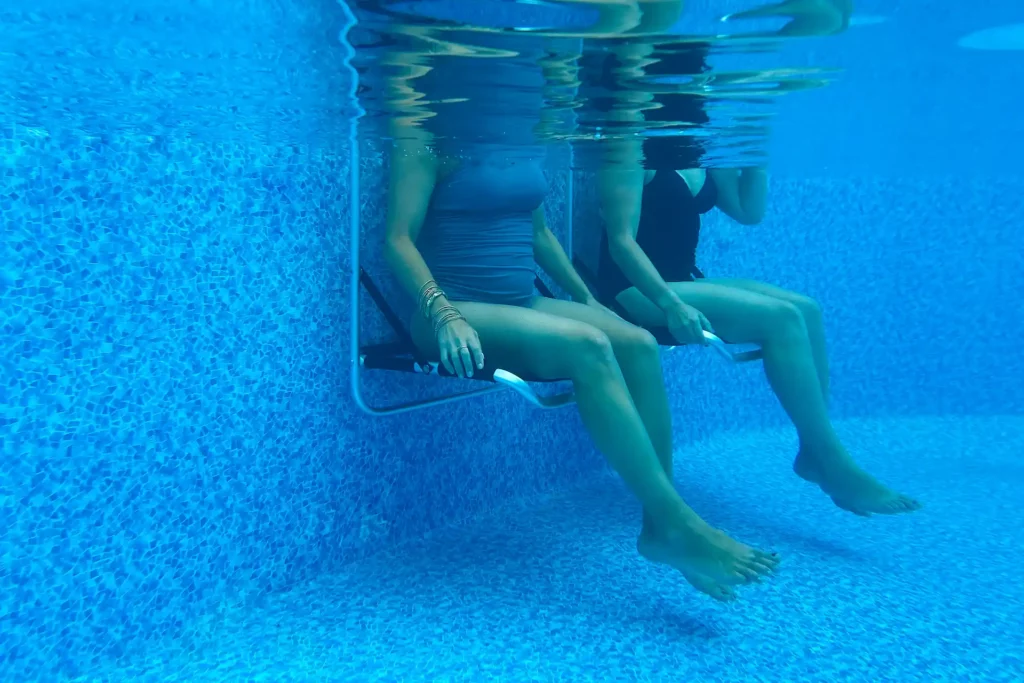Ladies sitting in the Edgemate chair underwater