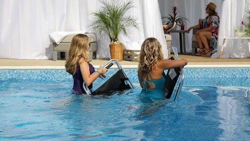 two women with the best pool chairs in a pool