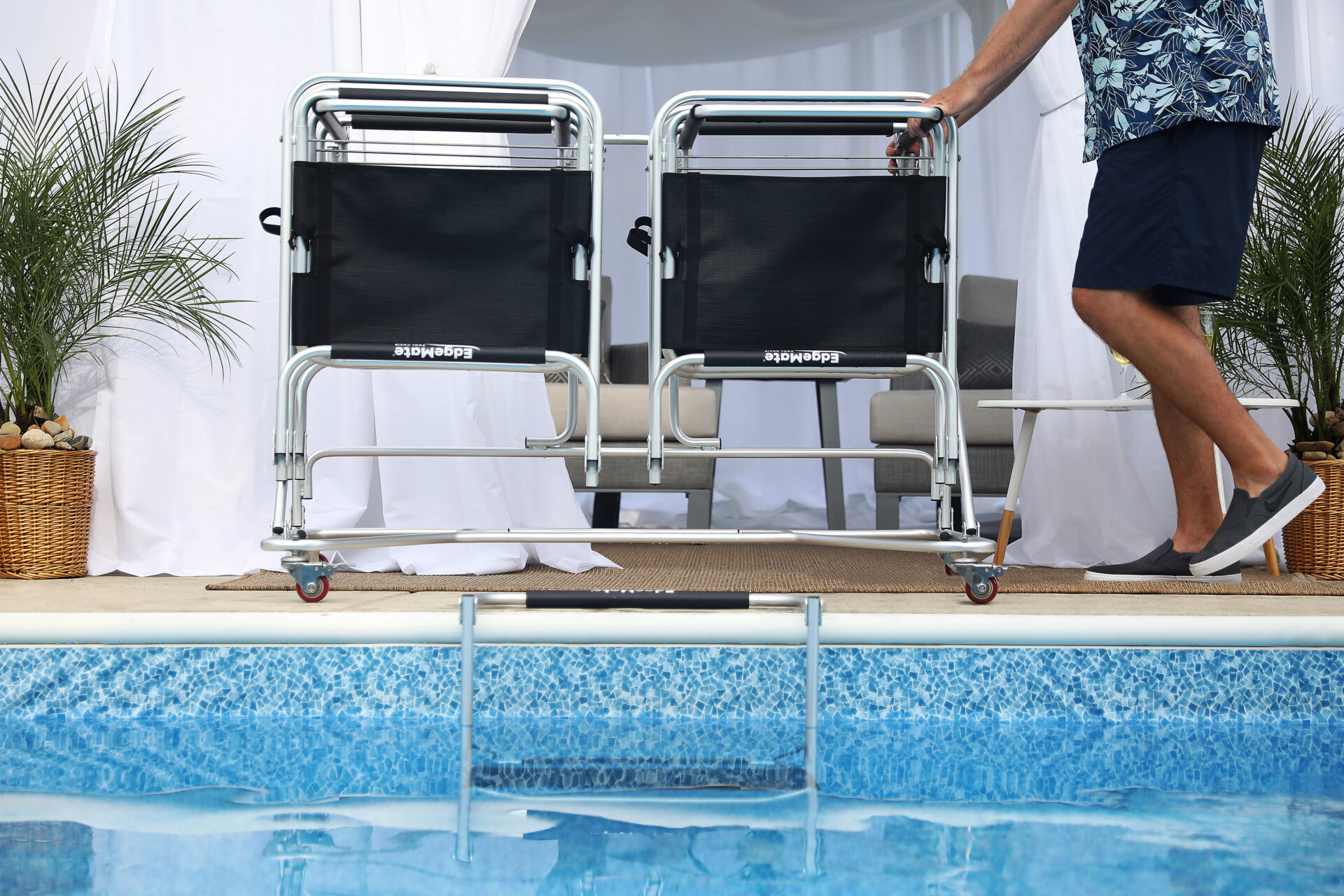 a man makes a hotel pool more accessible with EdgeMate Pool Chairs