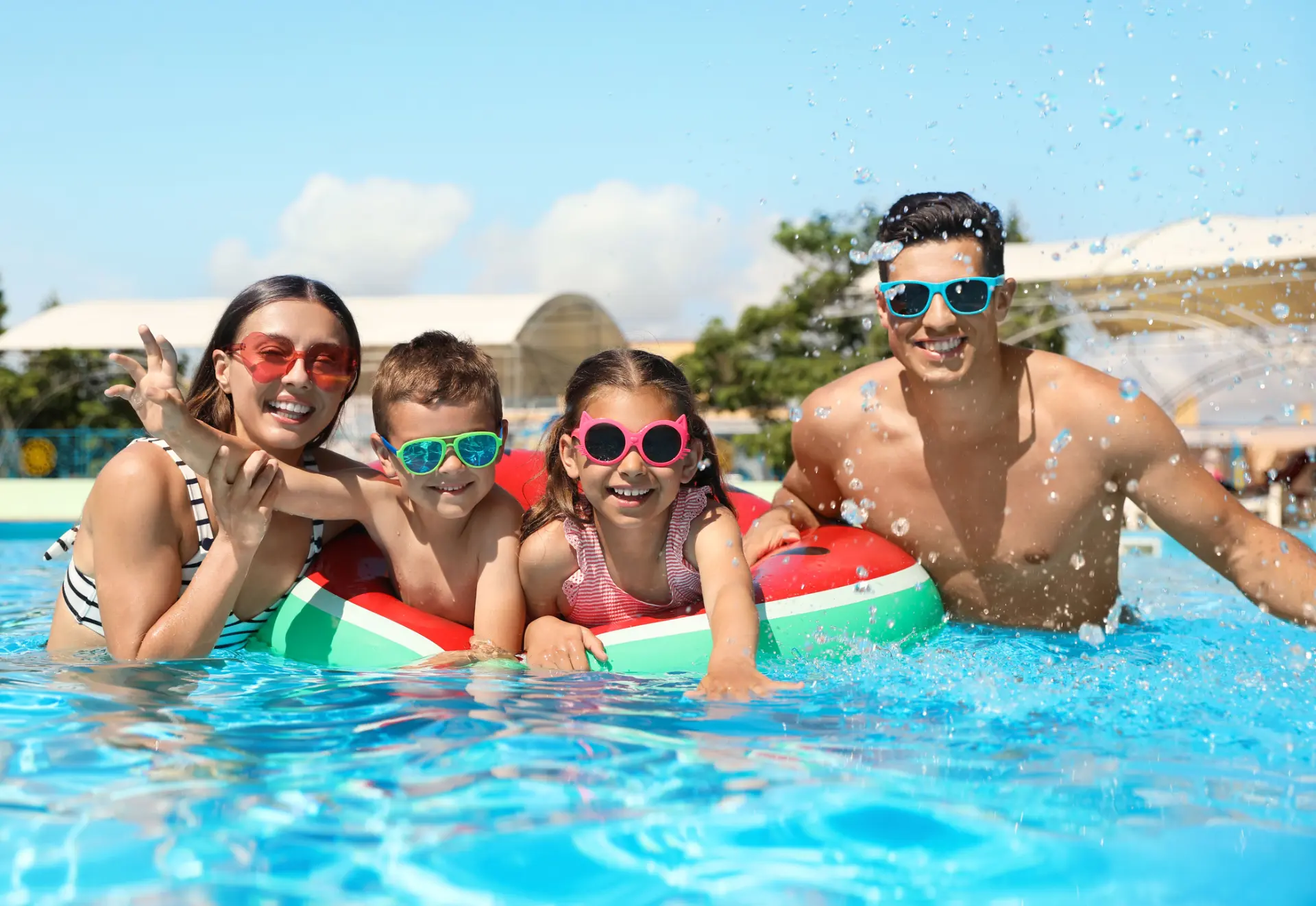 A family of four enjoy being in the pool in order to maximize time together on vacation.