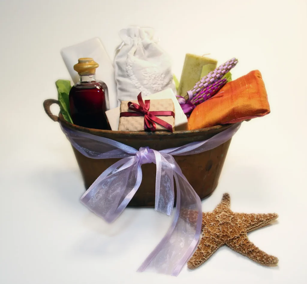 A gift basket holds multiple craft items like soap, bottled goods, candles, and textiles.